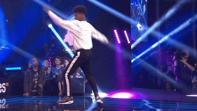 a man is doing a handstand in front of a sign that says snipes