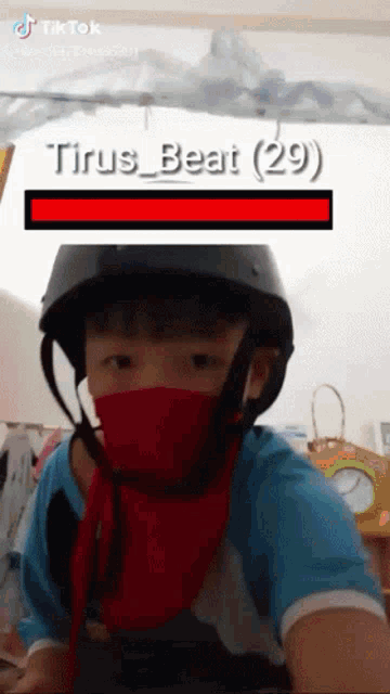 a boy wearing a mask and a helmet has tiktok written on the bottom right