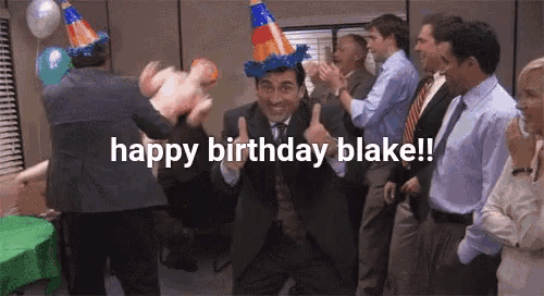 a group of people are celebrating a birthday with a man wearing a party hat giving a thumbs up