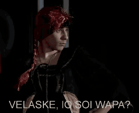 a woman with red hair is standing in a dark room .