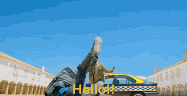 a man standing next to a taxi with the word hello written on the side
