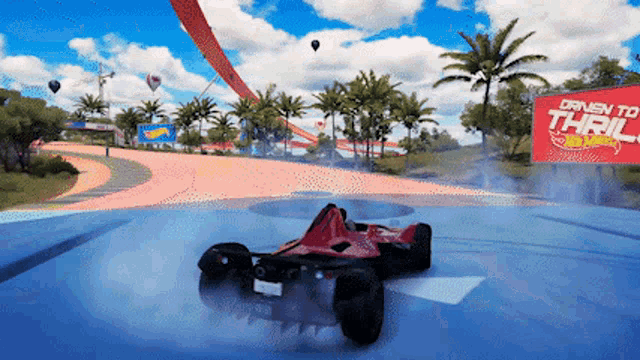 a hot wheels race car is driving down a track