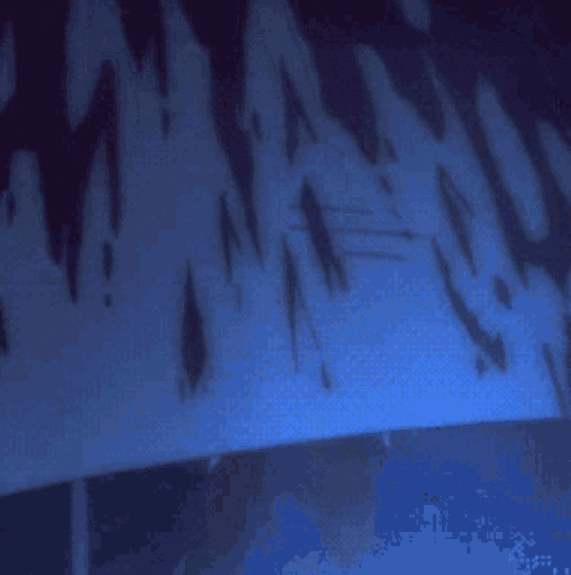 a blue background with a shadow of a person