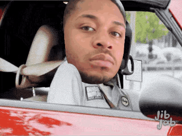 a man sitting in a car with jib jab written on the bottom