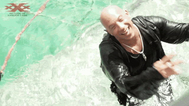 a bald man is swimming in a pool with the words return of xander case