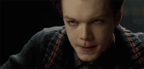 a close up of a person 's face with a sweater on
