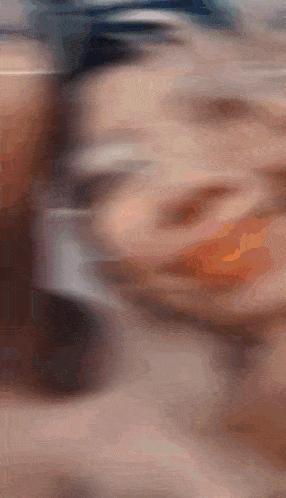 a blurry photo of a person 's face with a blurred background