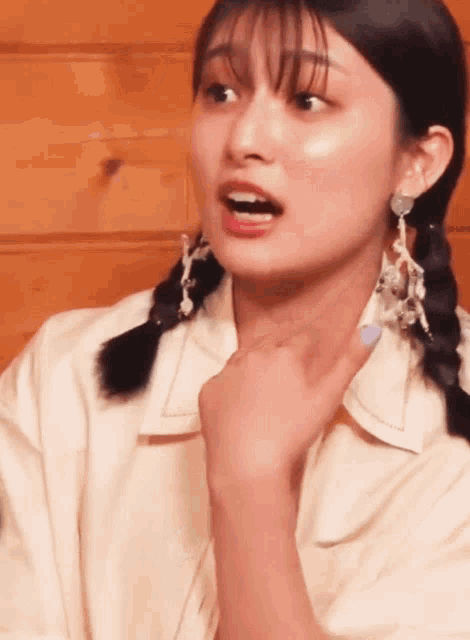 a close up of a woman 's face with a surprised look on her face