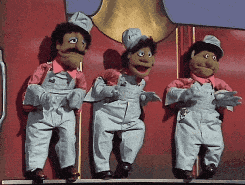 three cartoon characters are standing next to each other on a red wall