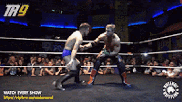 two men in a wrestling ring with the number 9 on the top