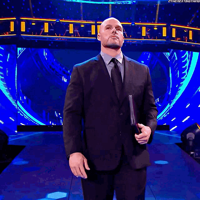 a man in a suit and tie is standing in front of a sign that says ' back down '