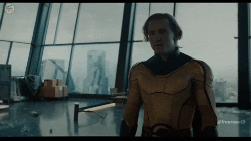 a man in a yellow superhero costume is standing in front of a window