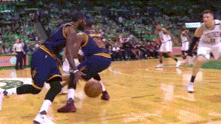 a basketball player with the number 8 on his jersey is dribbling the ball