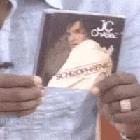 a person holding a book titled schizophrenic