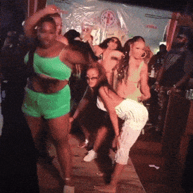 a group of women dancing in front of a sign that says ' coca cola ' on it