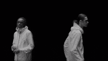 a black and white photo of two men wearing goggles
