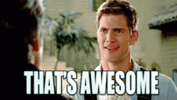 a man is smiling while talking to another man and the words `` that 's awesome '' are on the screen .