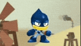 a blue cartoon character is holding a pair of scissors in his hand .