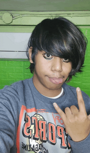 a young man wearing a shirt that says ' hoops ' on it
