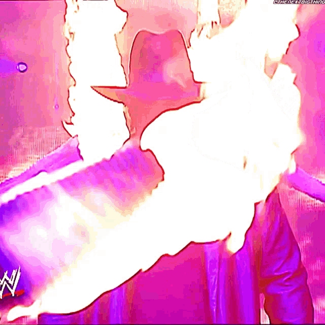 a wrestler with flames coming out of his mouth and a w logo in the corner