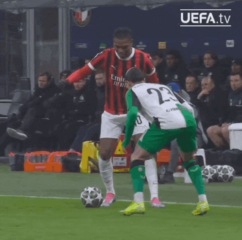 a soccer player wearing a number 23 jersey kicks the ball