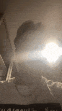 a person is taking a selfie with a light shining on them