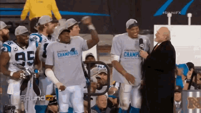 a group of football players wearing shirts that say conference champions on them