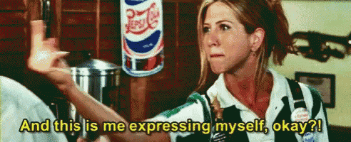 a woman is standing in front of a pepsi can and talking about expressing herself .