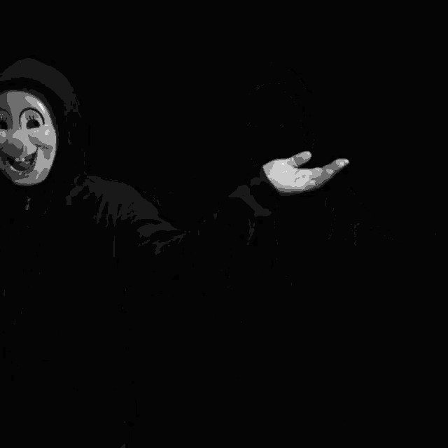 a person wearing a clown mask and a hoodie