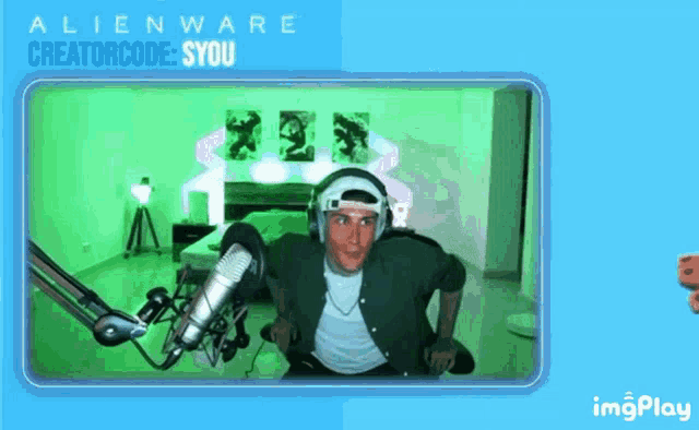 a man wearing headphones stands in front of a microphone with the words alienware creatorcode syou on the bottom left