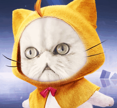 a white cat wearing a yellow hooded cape with a red bow