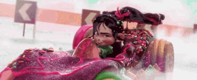 a cartoon girl is riding in a donut car with sprinkles on it .