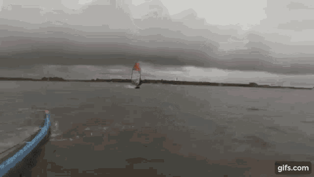 a person is riding a surfboard in a body of water .