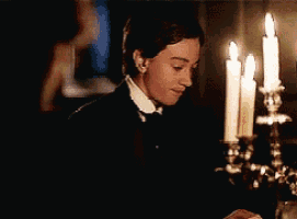 a man in a tuxedo says i cannot in front of lit candles