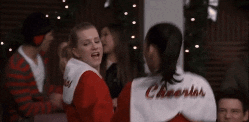 cheerleaders wearing red and white uniforms with the word cheer on them