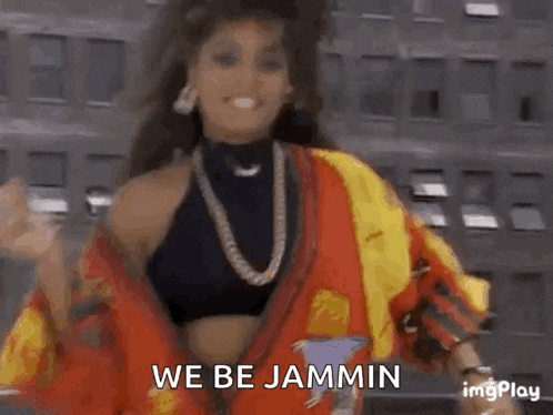a woman is dancing in front of a building with the words `` we be jammin '' .