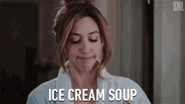 a woman in a bathrobe is making a face and eating ice cream soup .