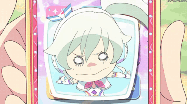 a picture of a girl with a surprised look on her face is being held by hothotmiso