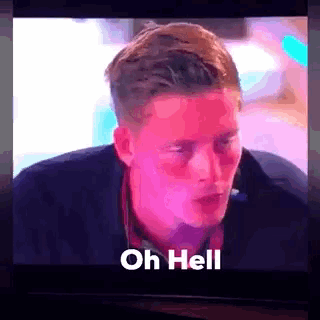 a man is sitting in front of a television with the words oh hell written on the screen .