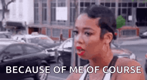 a woman is standing in front of a parking lot and talking to someone .