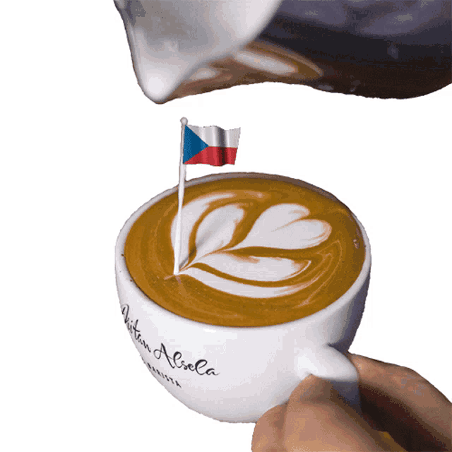 a cup of coffee with a flag sticking out of it that says written aliola