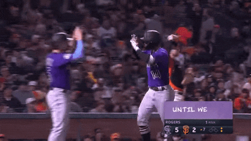 a group of baseball players wearing purple uniforms with colorado on the front