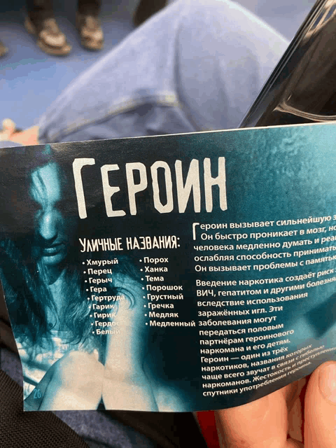 a person is holding a piece of paper that says ' heroes ' on it