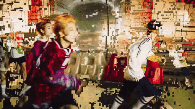 a group of people are dancing in front of a wall that says ' i love you '