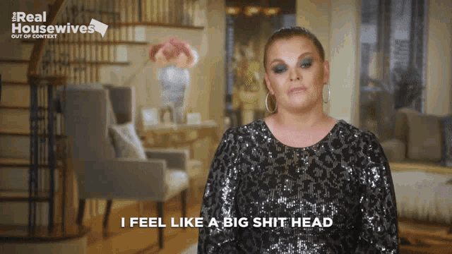 a woman says " i feel like a big shit head " in front of a living room