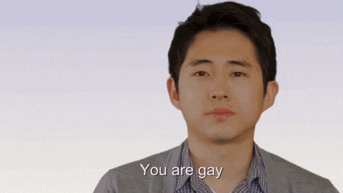 a man says " you are gay " in front of a white background