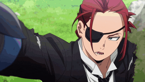 a man with red hair wearing a suit and tie
