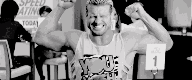 a black and white photo of a man flexing his muscles .