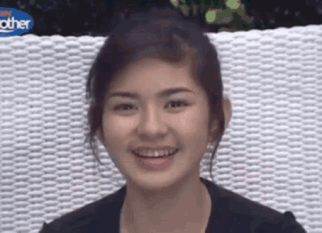 a woman with braces on her teeth is smiling while sitting on a chair .