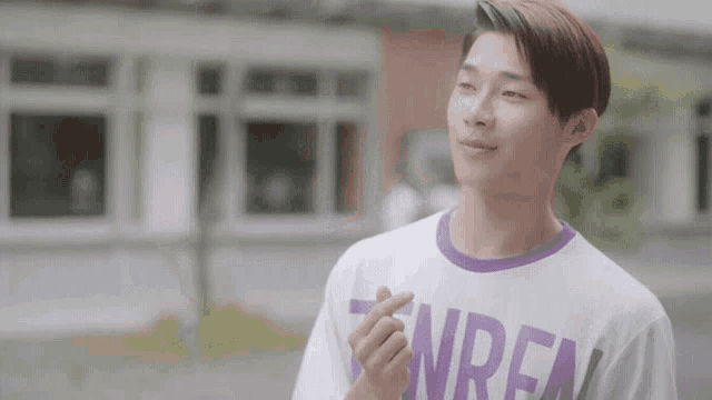 a young man wearing a white t-shirt that says nren on it